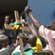A cross with the Zimbabwean flag wrapped around it is lifted during demonstrations.